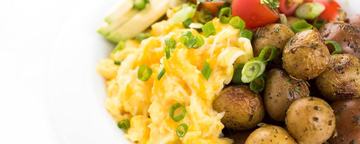A cheesy egg and potato breakfast bowl.