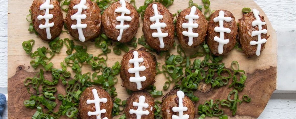 A plate of little potatoes shaped like mini footballs.