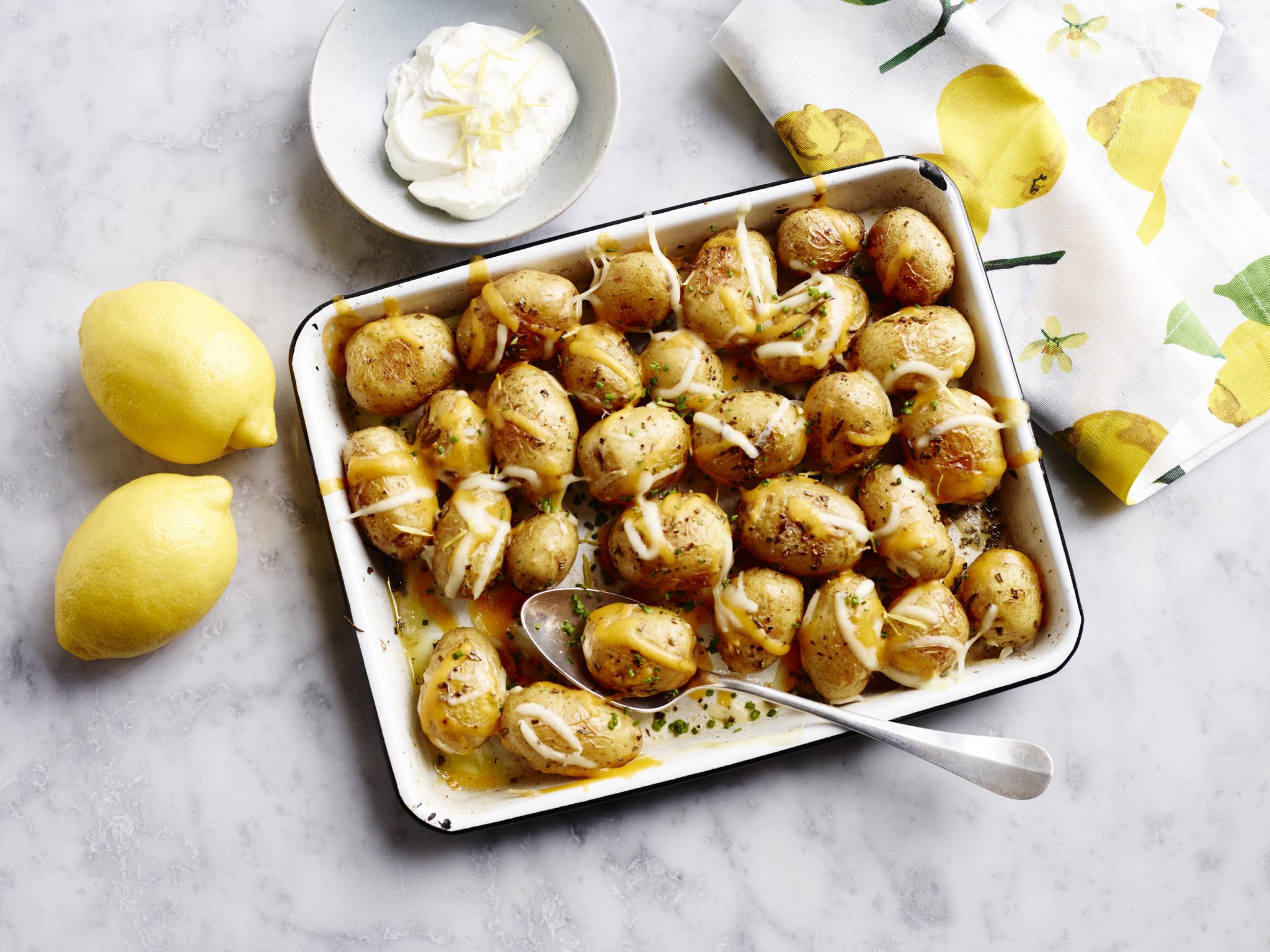 A roasting tray of cheesy little potatoes.